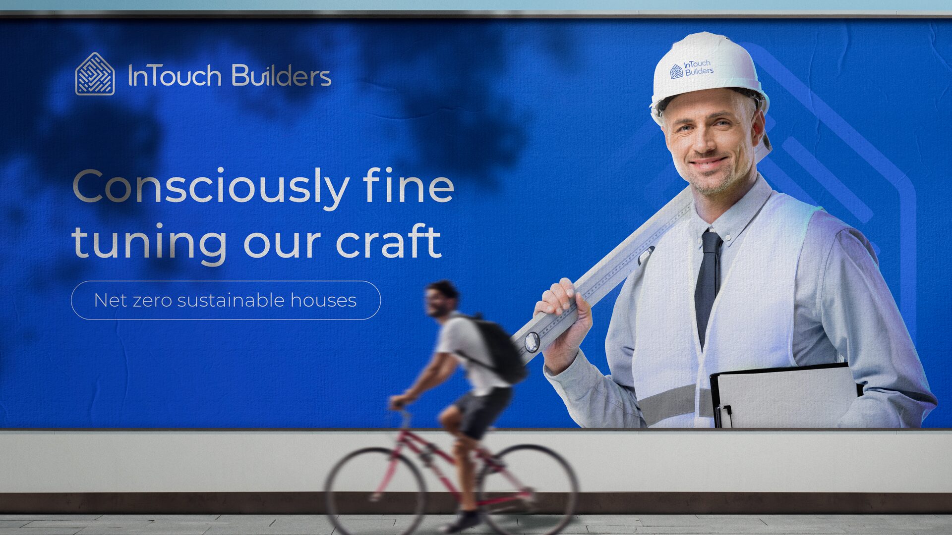 FIG.16 — a roadside billboard reading Consciously fine tuning our craft with the net zero sustainable houses pill beneath
