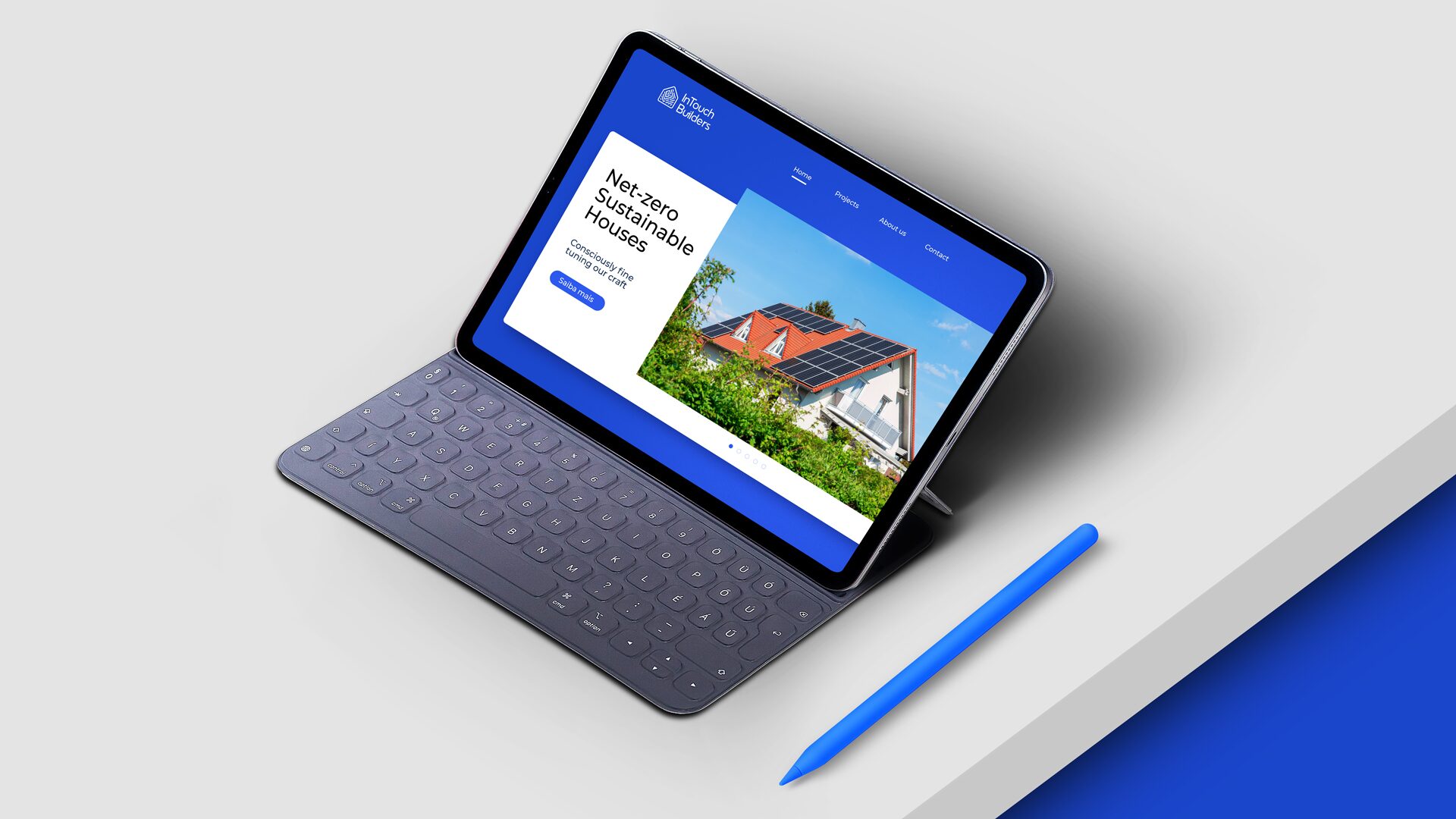 FIG.17 — the InTouch Builders site shown on a tablet with keyboard and stylus on a pale desk